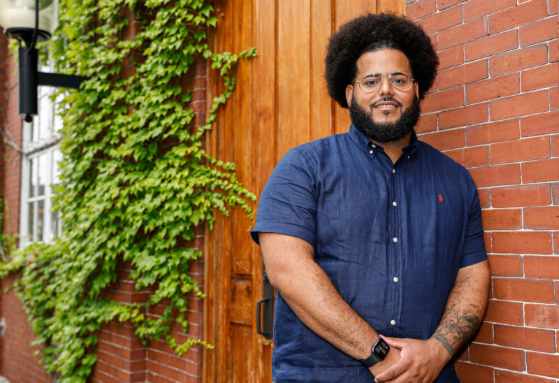 Andres Mejia standing in front of the Charitable Foundation's 37 Pleasant Street office in Concord, NH. (Photo by Cheryl Senter).