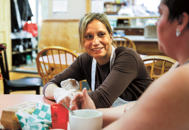 Cindy Stevens serves up a warm meal at the Claremont Soup Kitchen